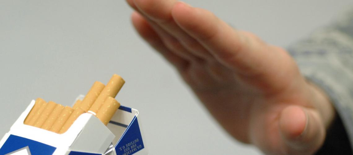 Hand refusing offered cigarettes